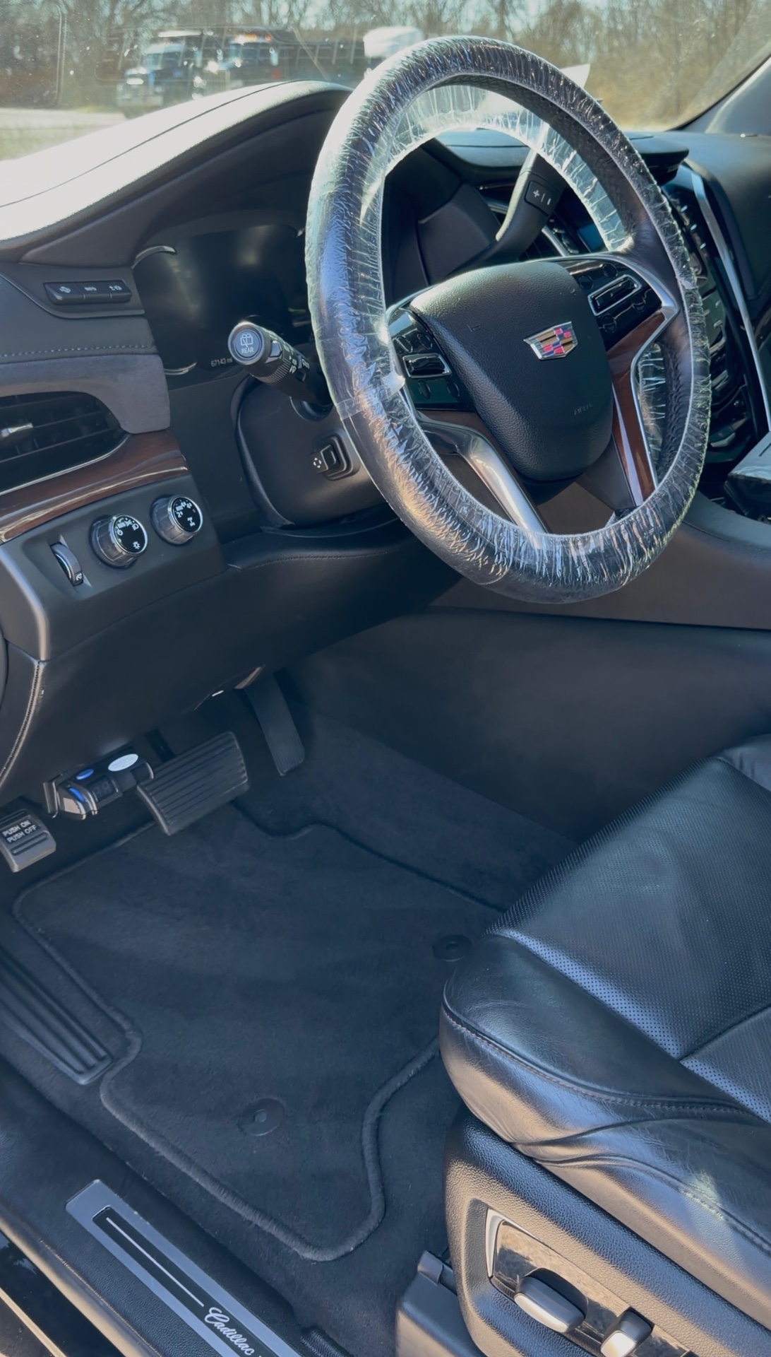Cadillac Escalade interior detailed with protected steering wheel and clean floor mats