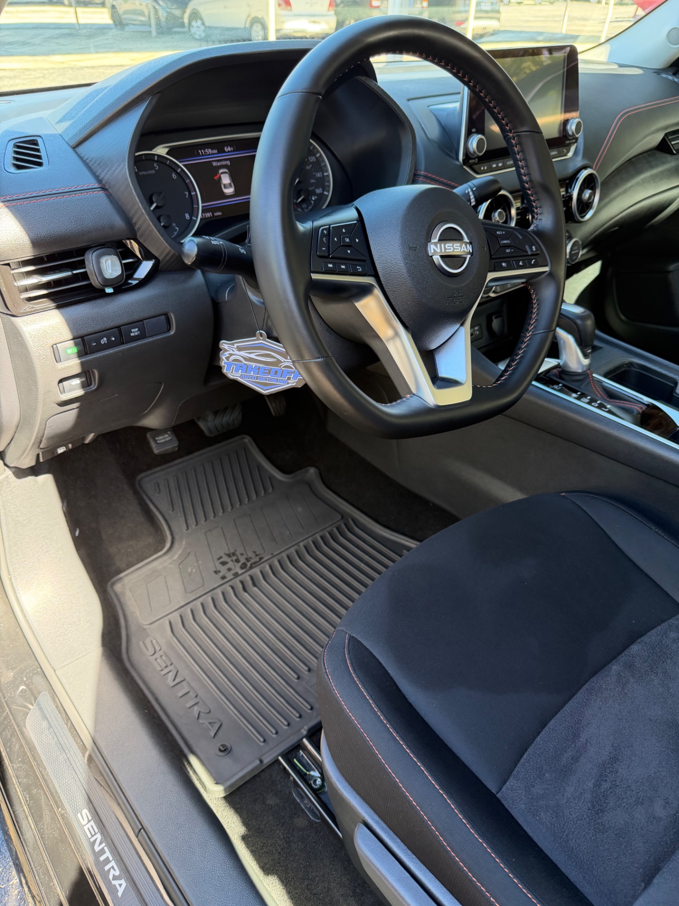 Nissan Sentra cockpit vacuumed and wiped with a clean dashboard and seats