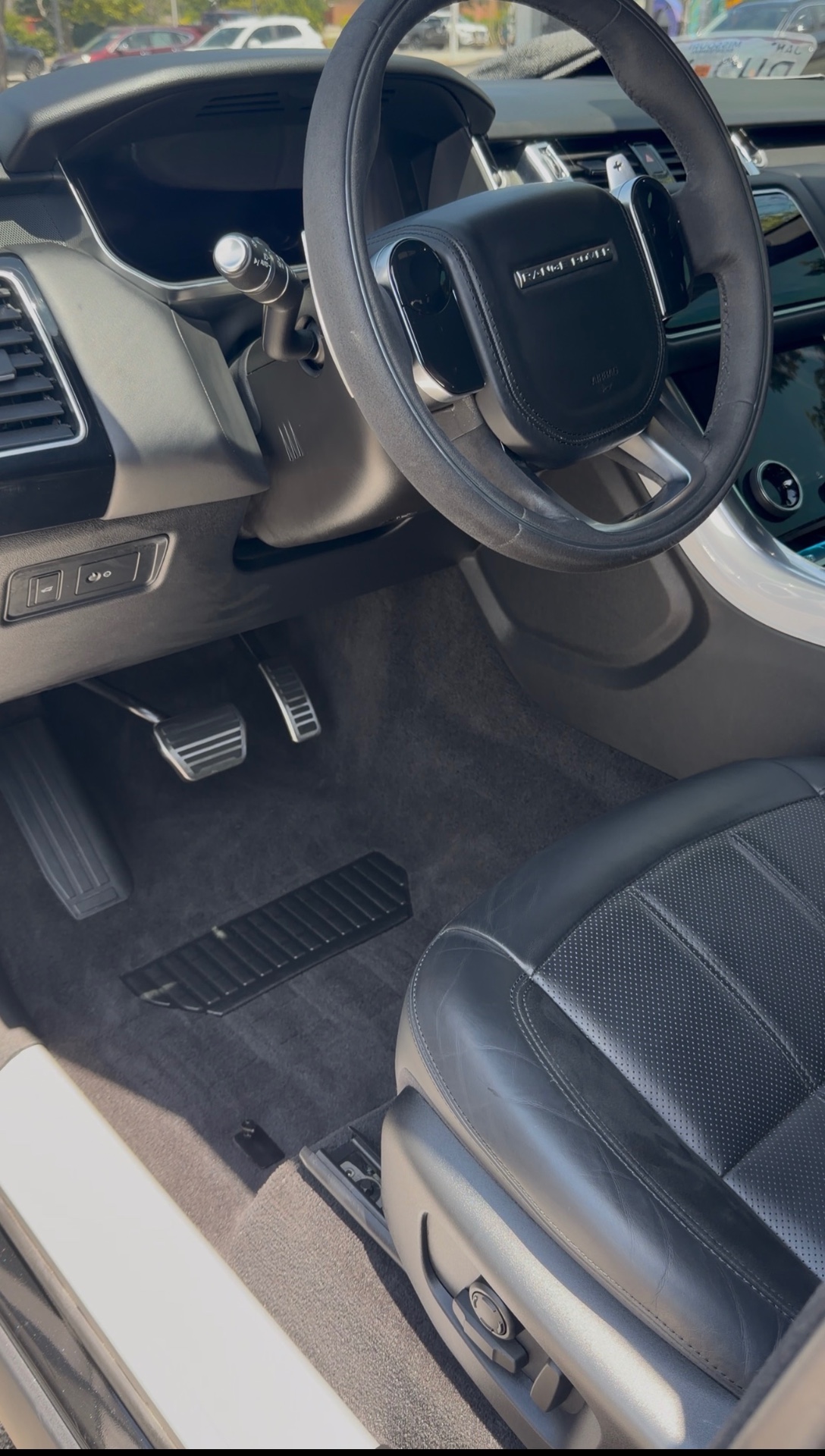 Range Rover Sport interior with spotless carpet, leather seat and clean dashboard