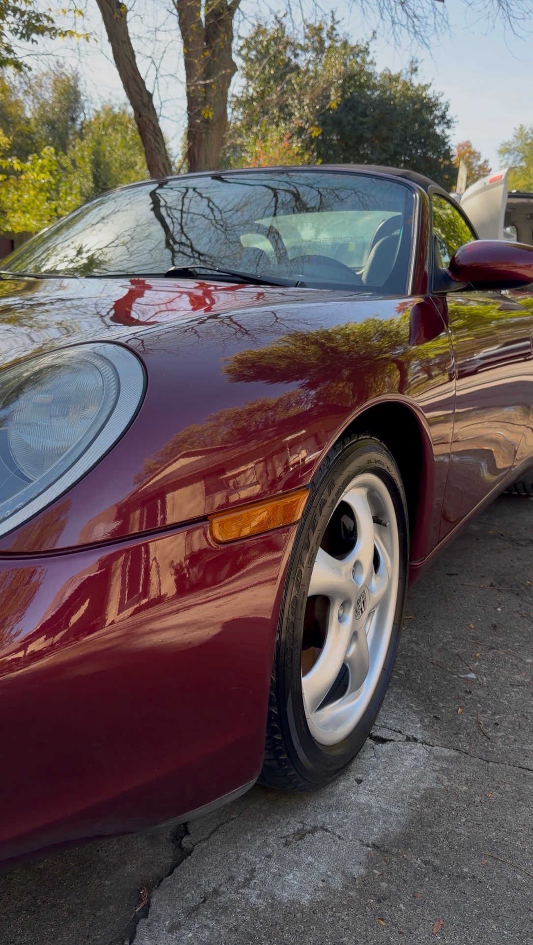 Burgundy Porsche Boxster with a mirror-gloss paint finish after a detail