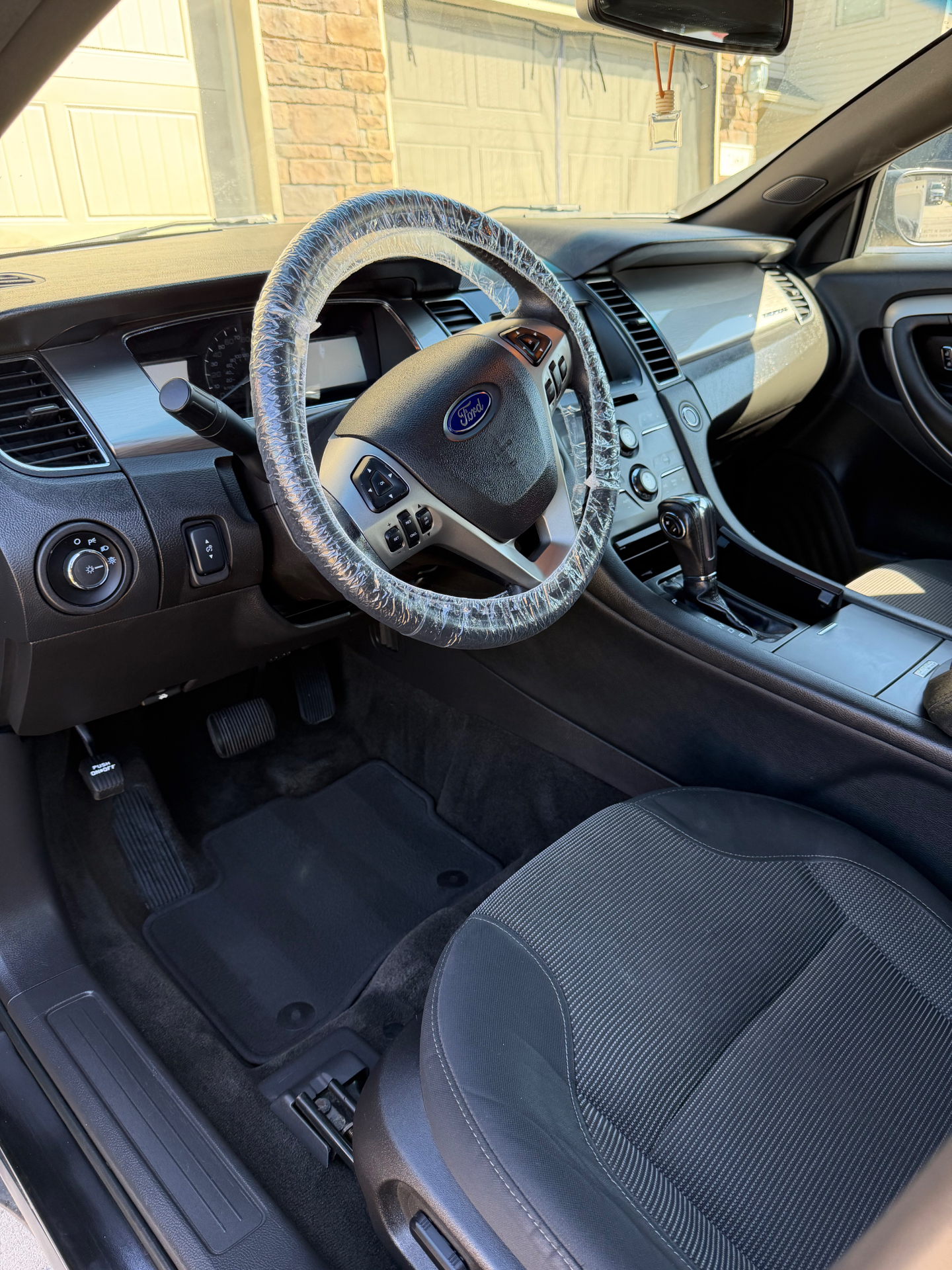 Freshly detailed Ford interior with steering wheel cover and clean dashboard